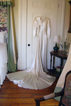 Photo of wedding dress in bedroom
