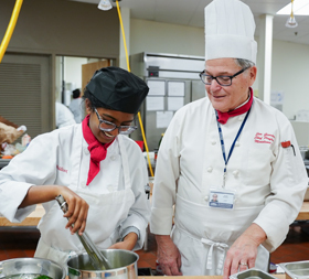 Photo of Culinary Student and Professor Cooking