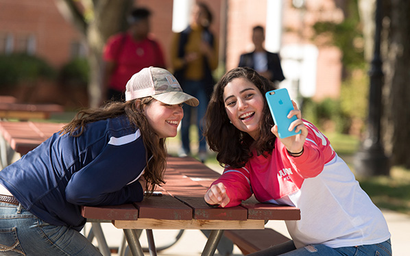 Photo: Student taking a selfie on the Bedford Quad