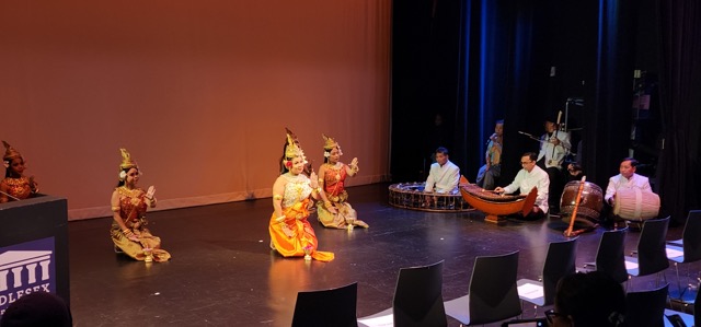 women sitting on stage for a cultural dance